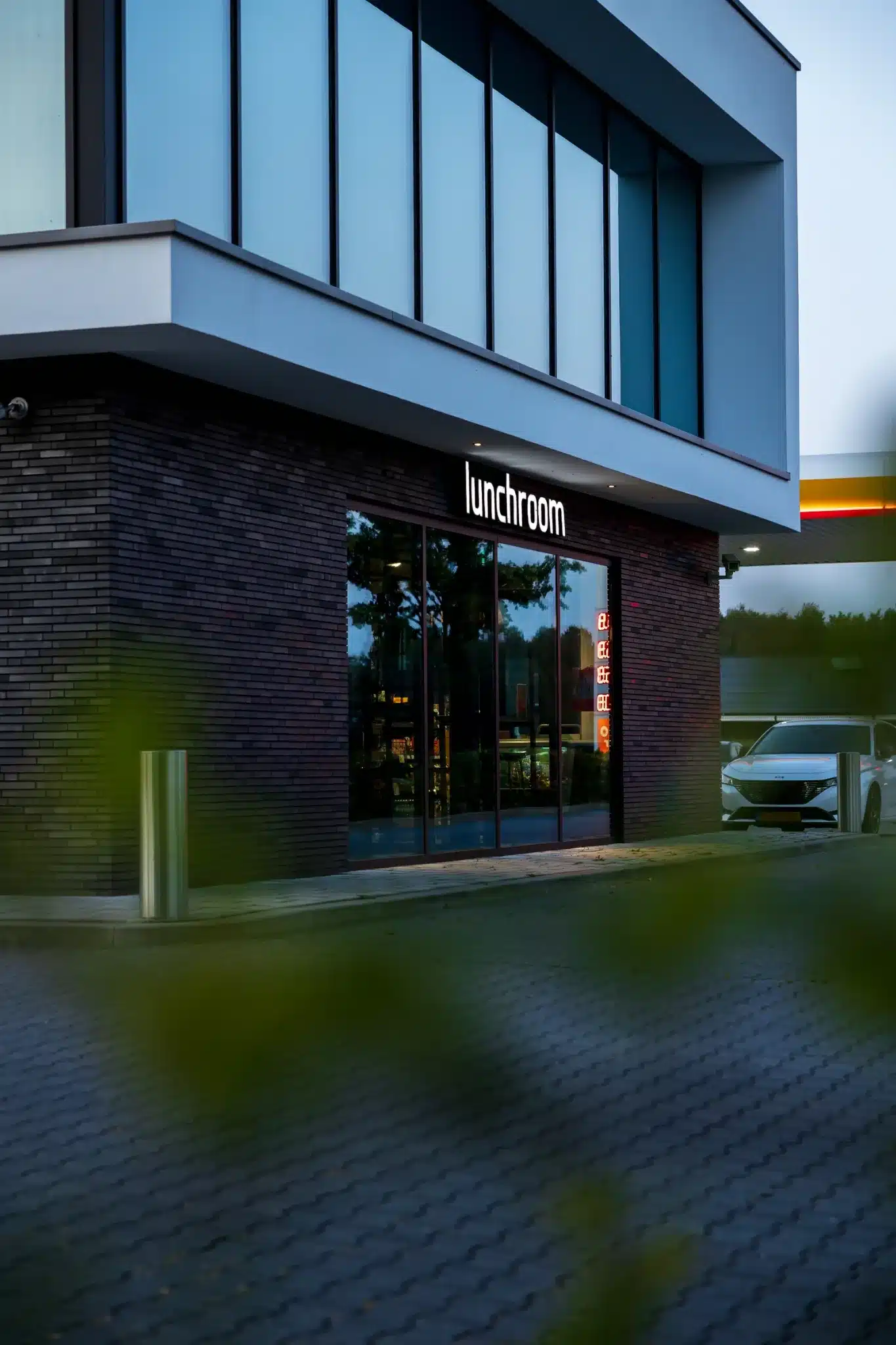 Totaaloverzicht van het OQ-Value tankstation in Raalte bij schemering.